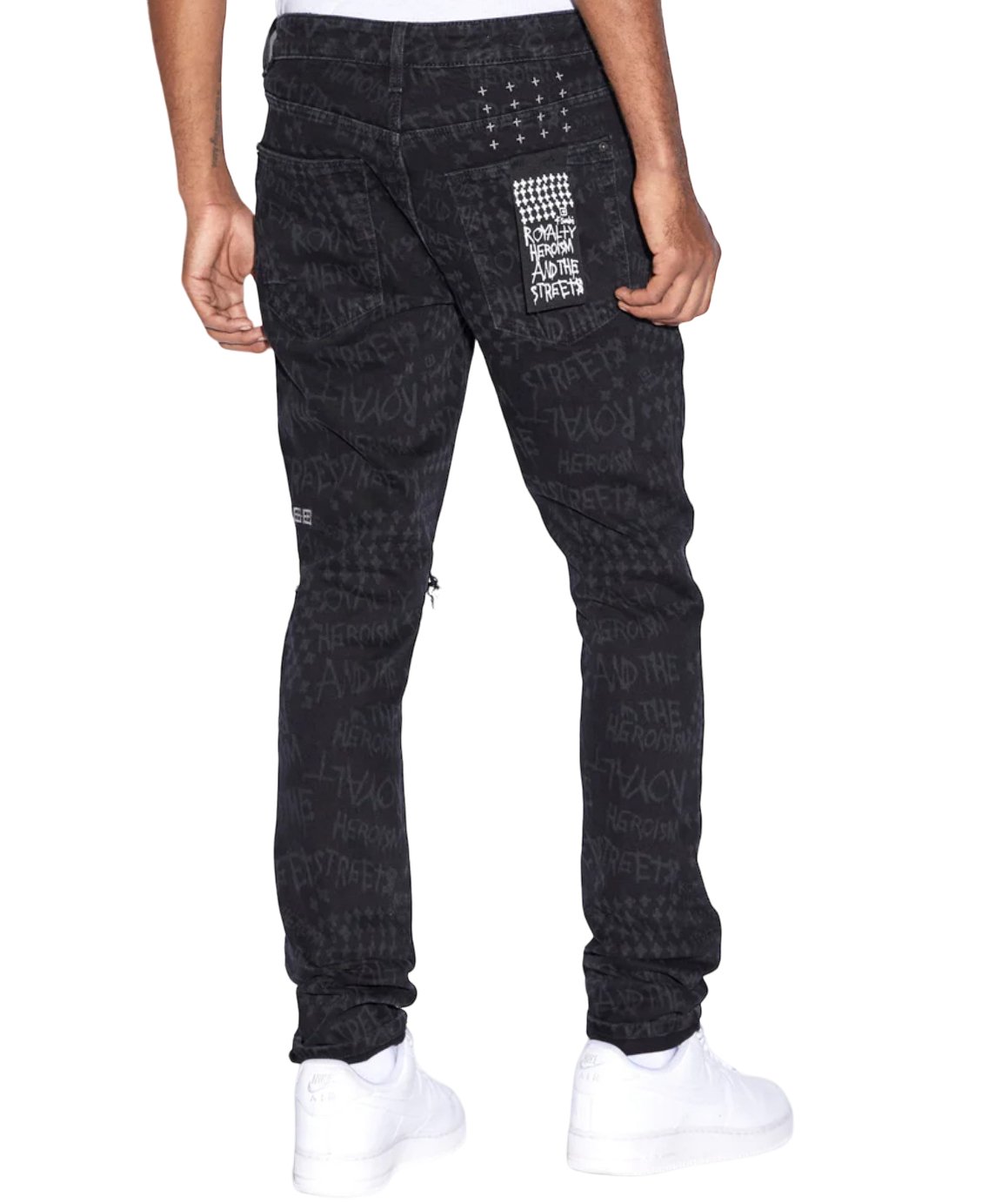 The back view of a man wearing Ksubi Van Winkle Heroism Black ripped skinny jeans, featuring Ksubi-branded hardware.