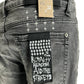 A pair of black skinny jeans with a tag that says KSUBI VAN WINKLE CHAMBER BLACK.