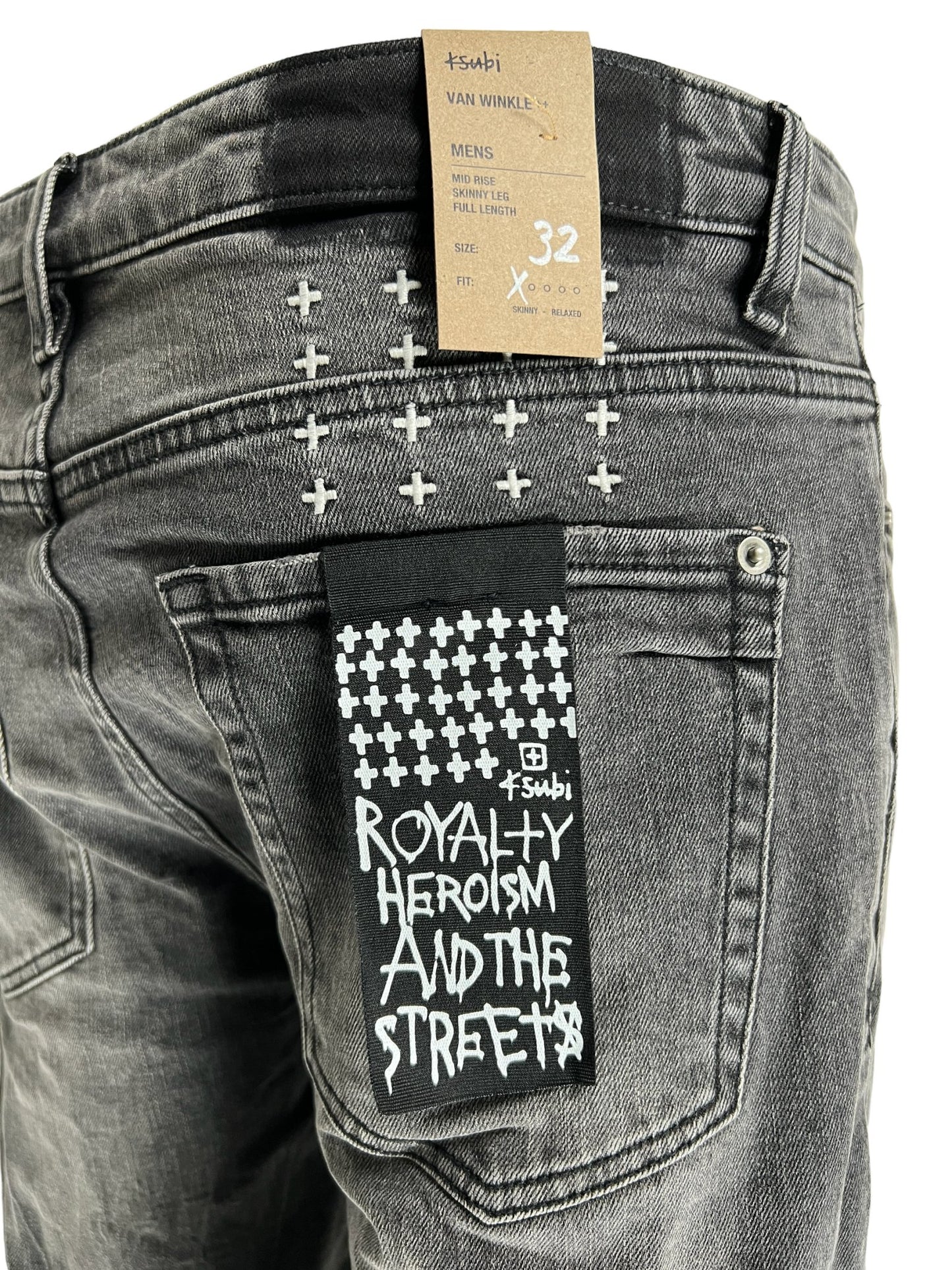 A pair of black skinny jeans with a tag that says KSUBI VAN WINKLE CHAMBER BLACK.