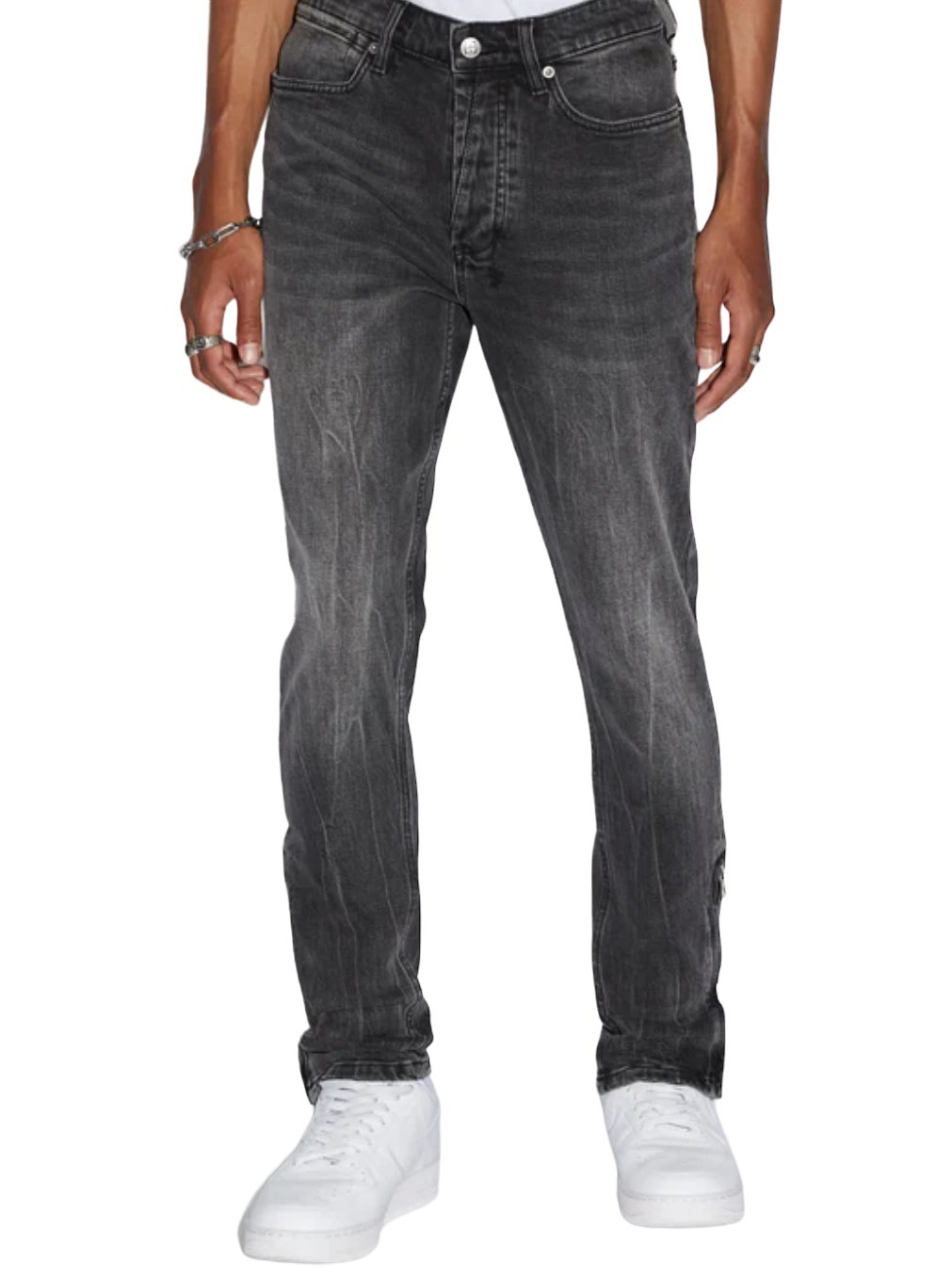 A man wearing KSUBI VAN WINKLE CHAMBER BLACK skinny jeans and a white t-shirt.