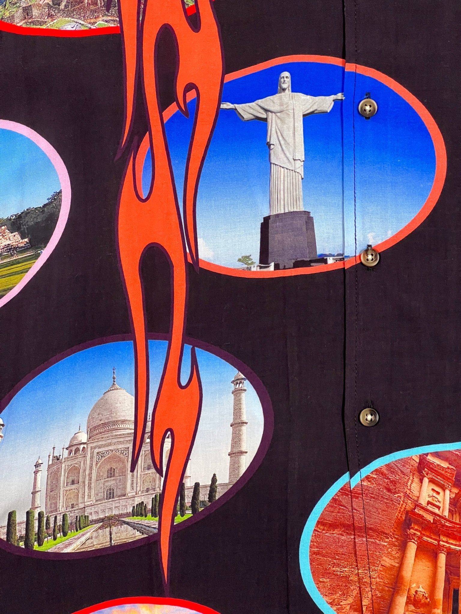 A PLEASURES 7 WONDER CAMP SHIRT BLK with a lot of pictures on it, featuring brown horn buttons.