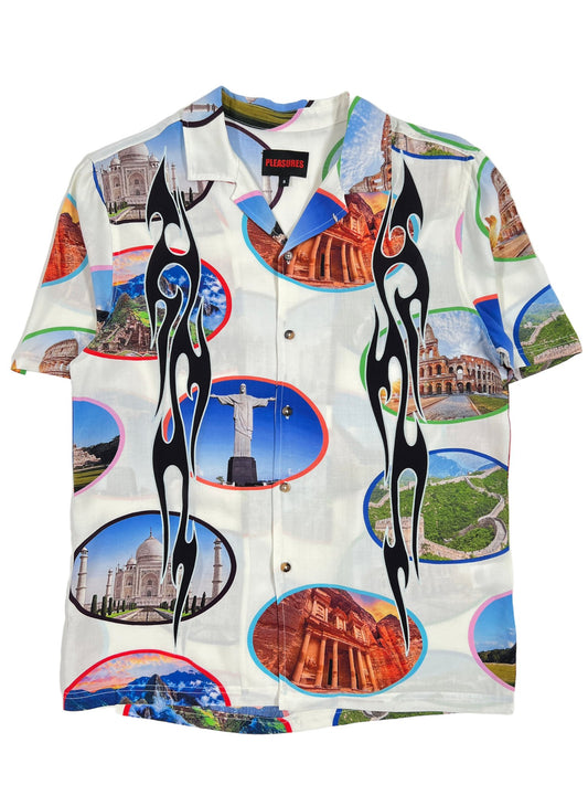 A white PLEASURES 7 Wonder Camp Shirt with various images on it, featuring Brown Horn buttons.