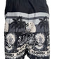 A black cotton swim trunk with palm trees and palm trees on it, featuring a relaxed fit, like the PLEASURES BEACH SHORT BLACK by PLEASURES.