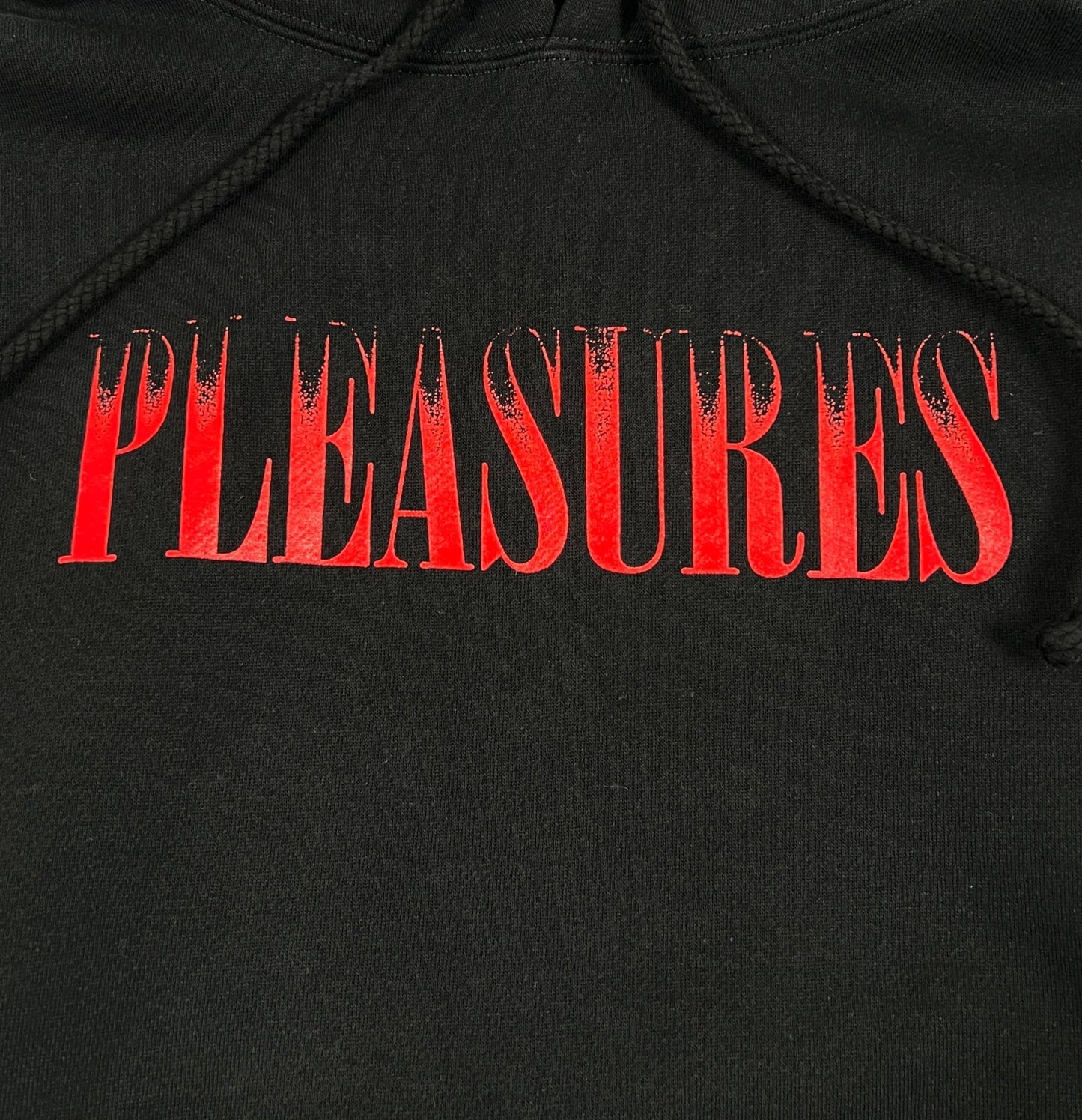 PLEASURES CRUMBLE HOODIE BLACK, emphasizing style and comfort.