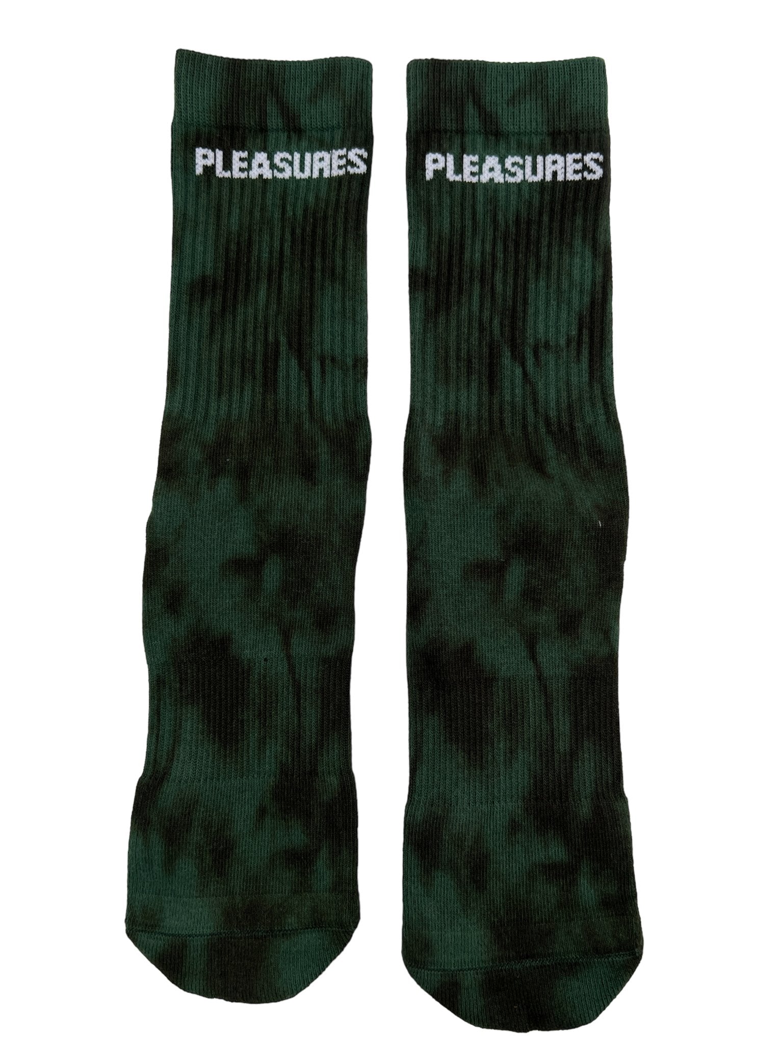 The Pleasures Indie Dye Socks Hunter feature "PLEASURES" in white text on two green socks, adding edgy style to any outfit.