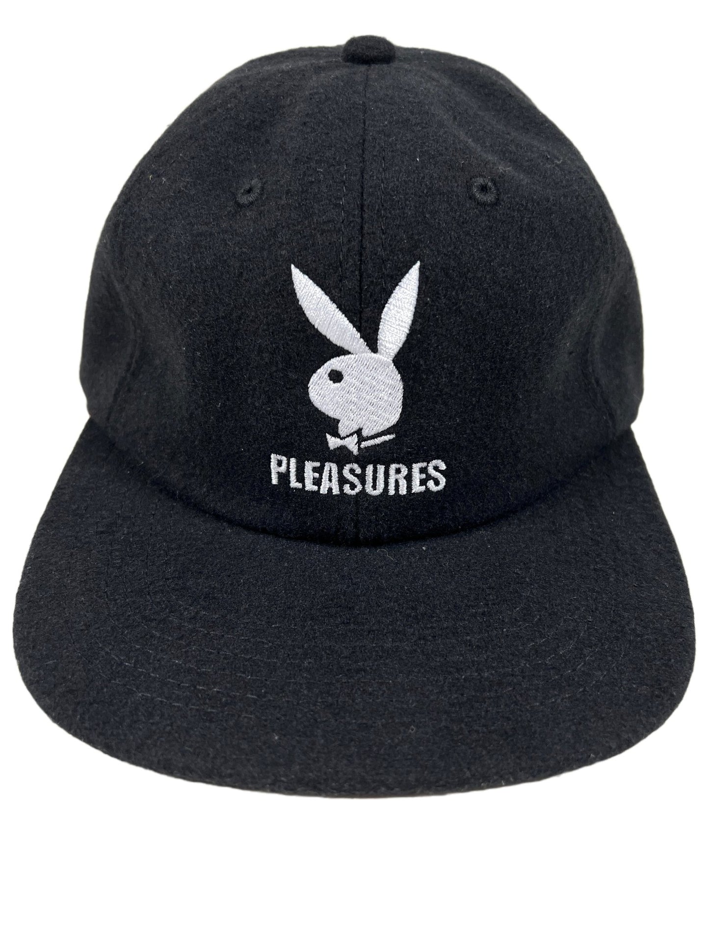 A black wool hat with the word PLEASURES on it. 
Product Name: PLEASURES PB WOOL STRAPBACK HAT BLACK 
Brand Name: PLEASURES