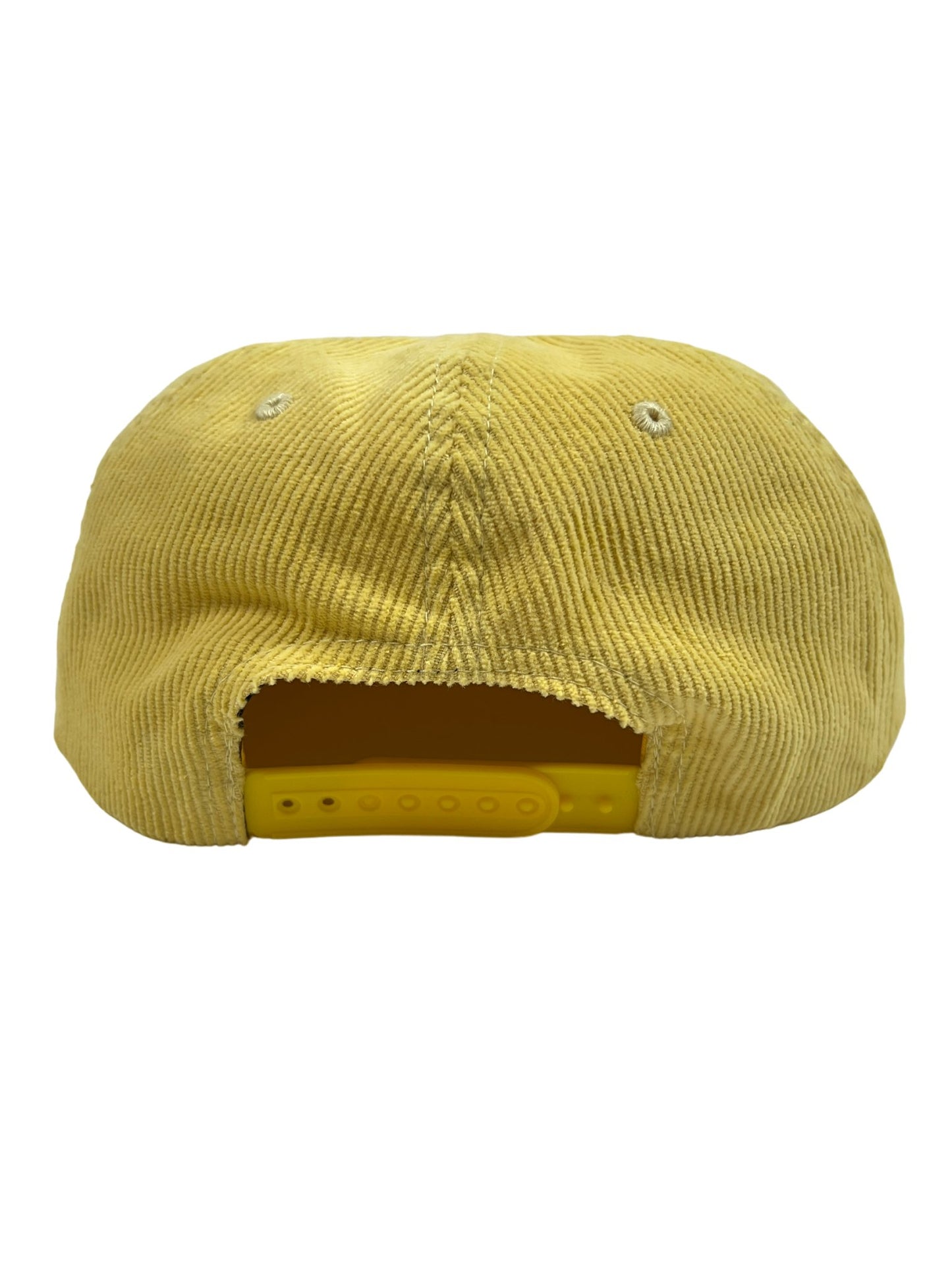 The back of a PLEASURES yellow cotton corduroy hat with a snapback strap.