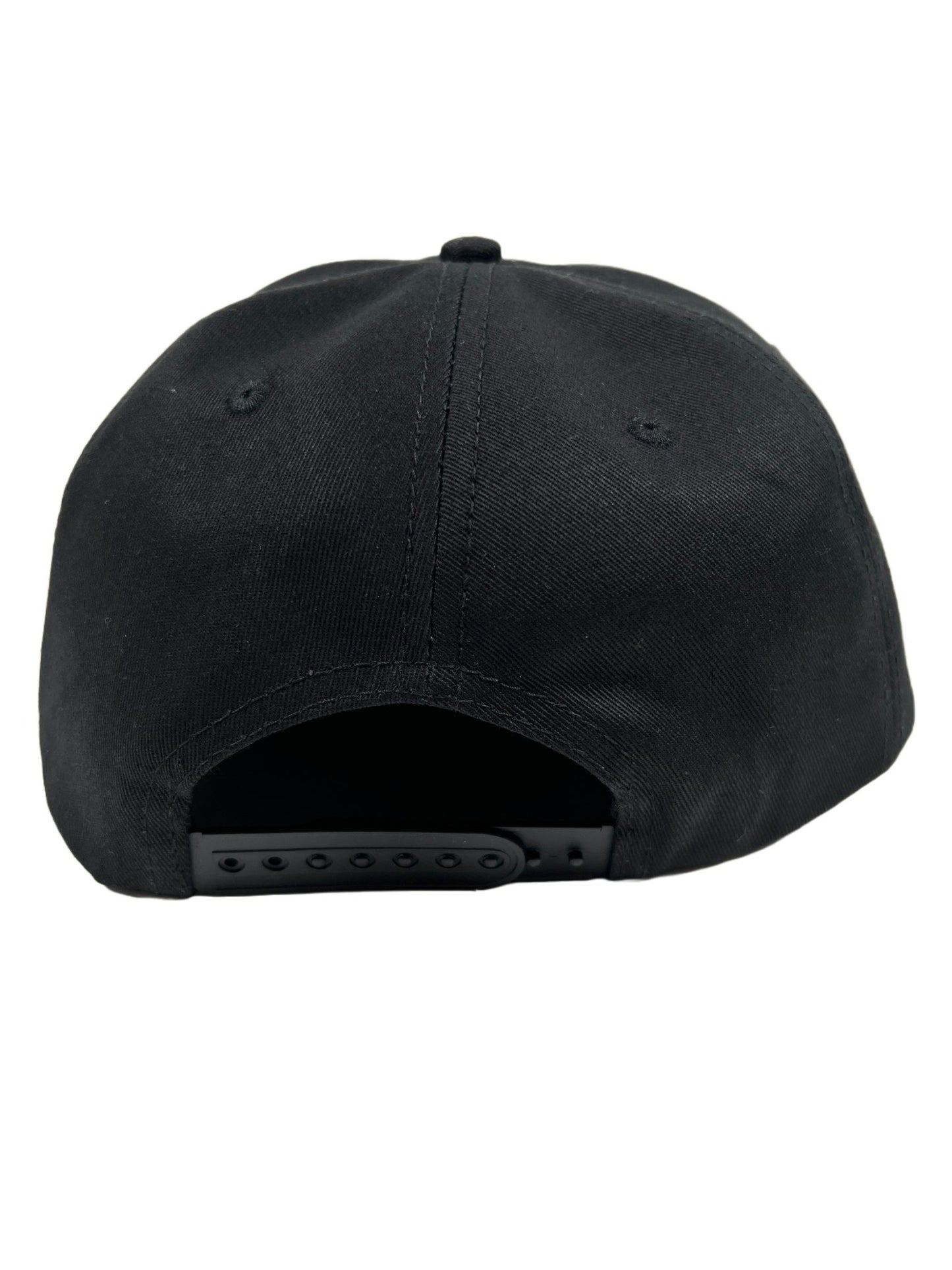A PLEASURES black embroidered snapback hat on a white background.