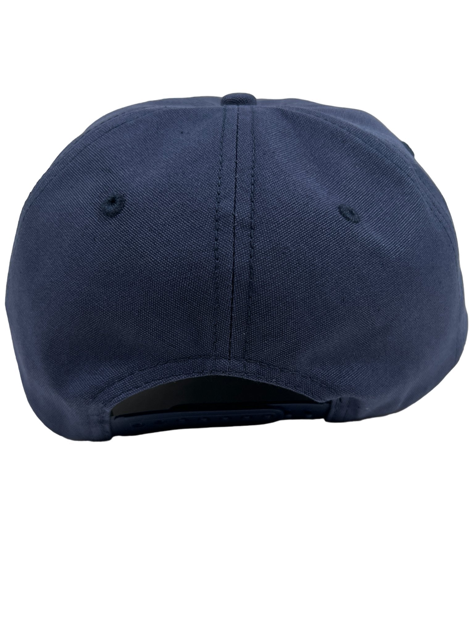 The Pleasures Soul Snapback Nvy by PLEASURES is a navy blue cotton baseball cap, designed in collaboration with Triple 5 Soul, featuring an adjustable snap closure and shown from the back.
