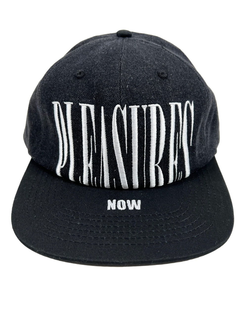 A PLEASURES denim ball cap with the word pleasures logo embroidered on it.