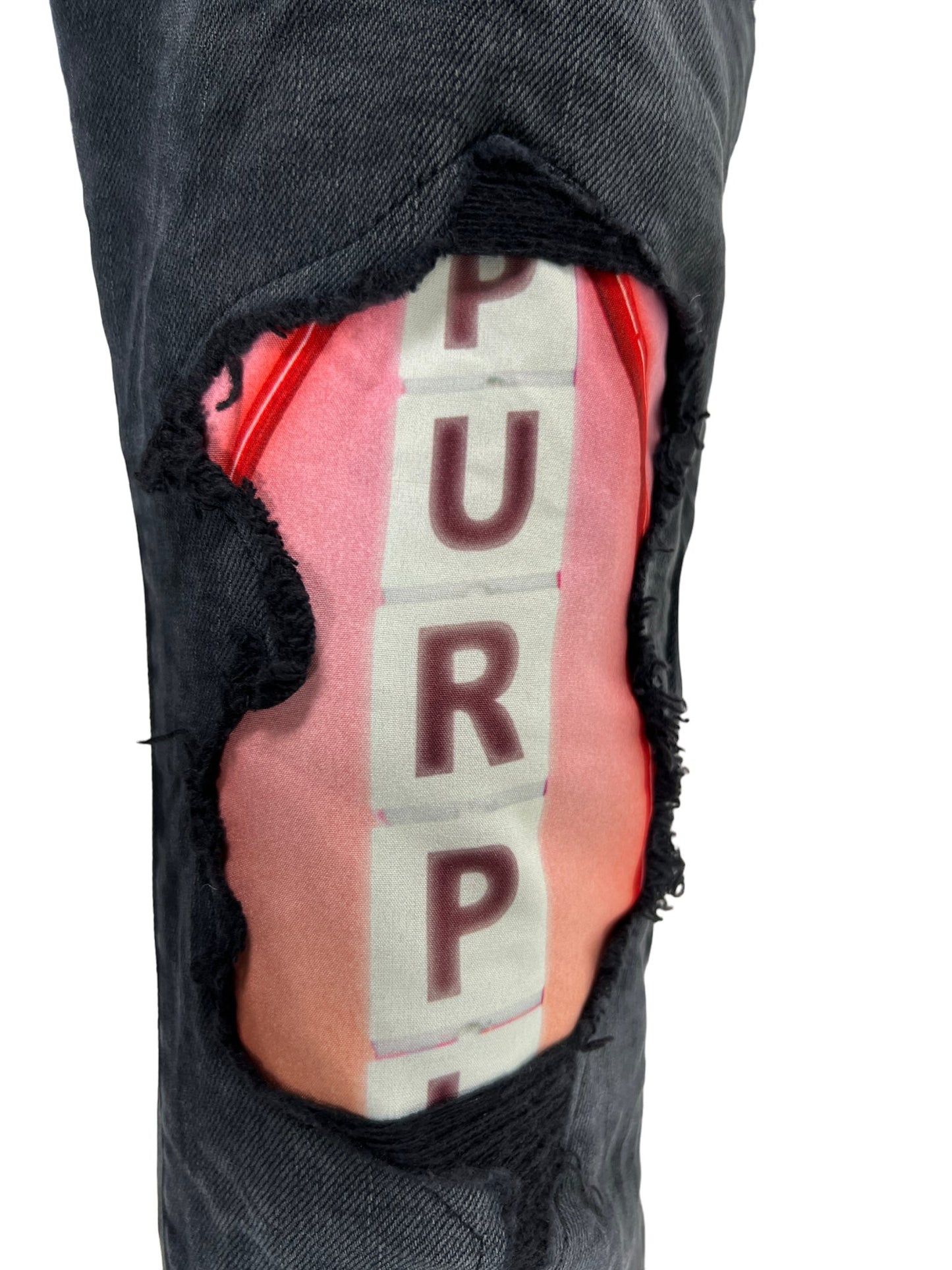 A pair of PURPLE BRAND skinny jeans with the word "purple" on them.