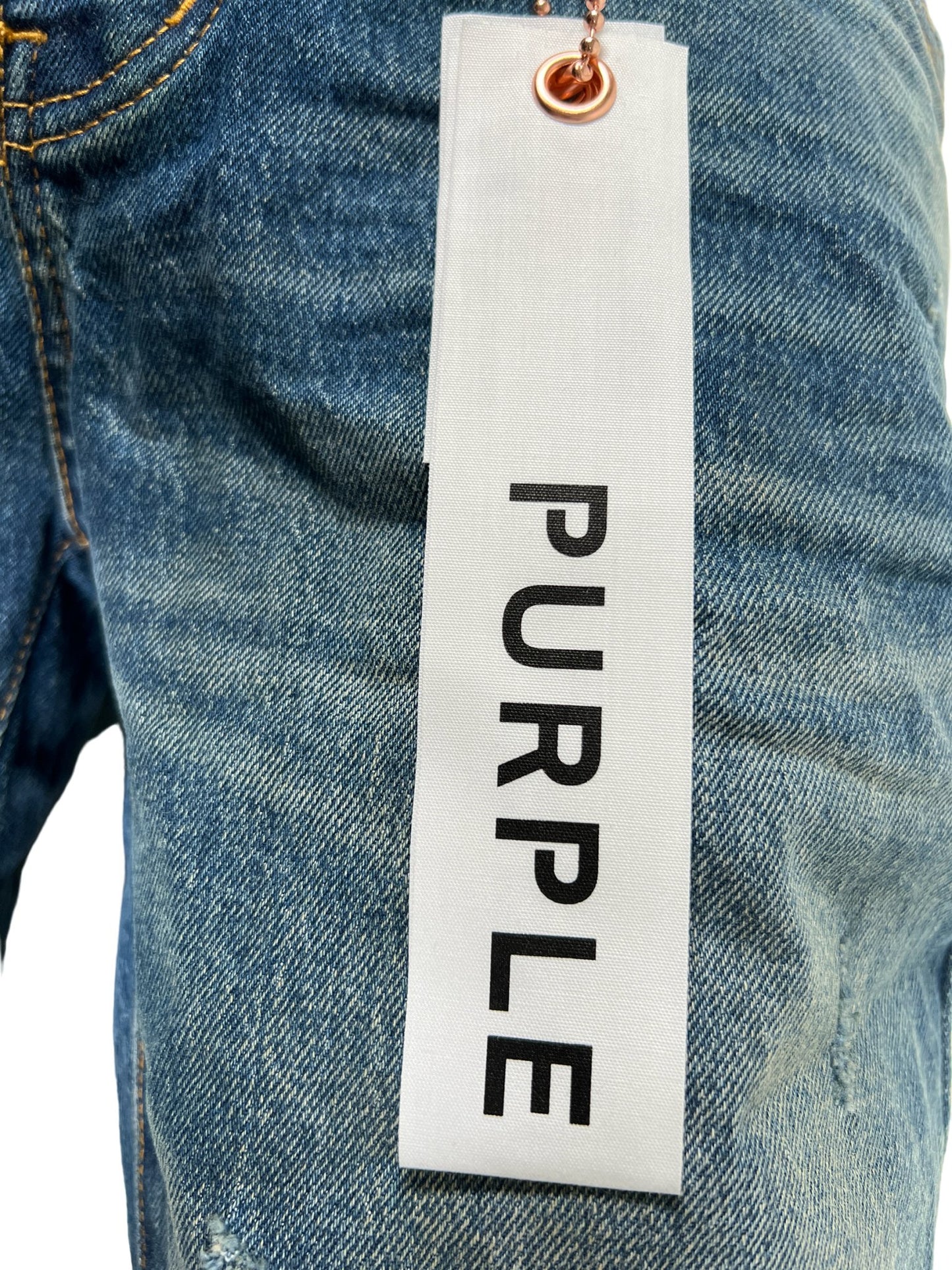 A pair of PURPLE BRAND jeans with a label that says purple.