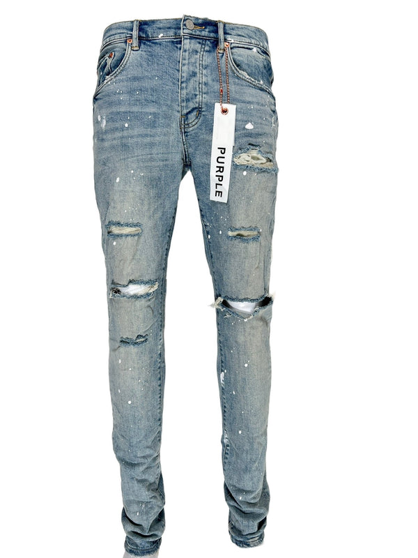 A pair of PURPLE BRAND ripped jeans with a tag on them, known for their comfort.