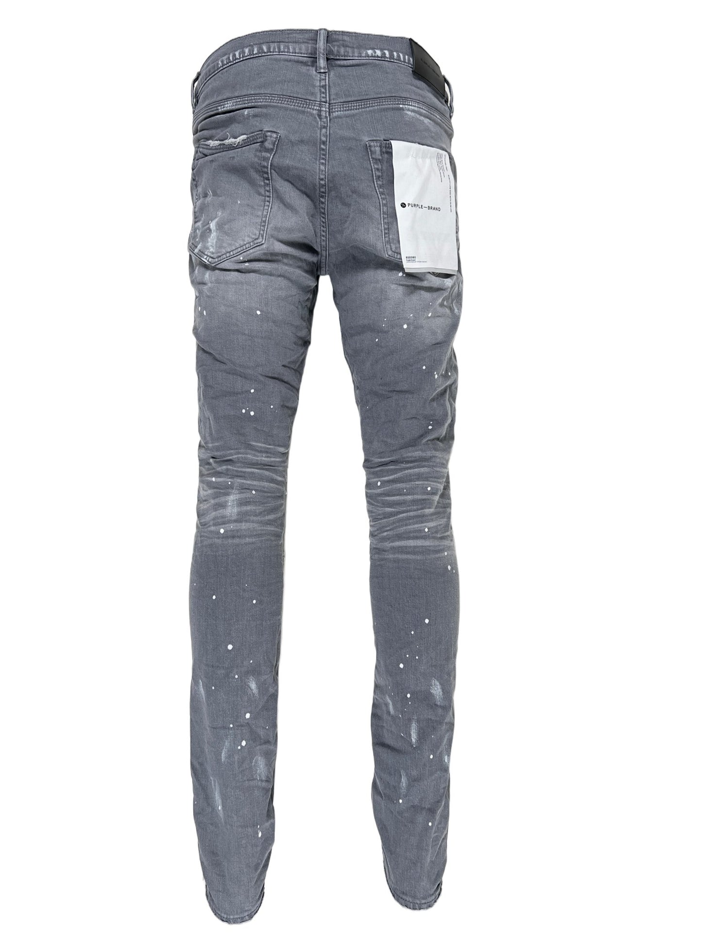 A pair of PURPLE BRAND jeans in P001-WGKS WORN GREY KNEE SLIT with white paint splatters on them, featuring belt loops for added functionality.