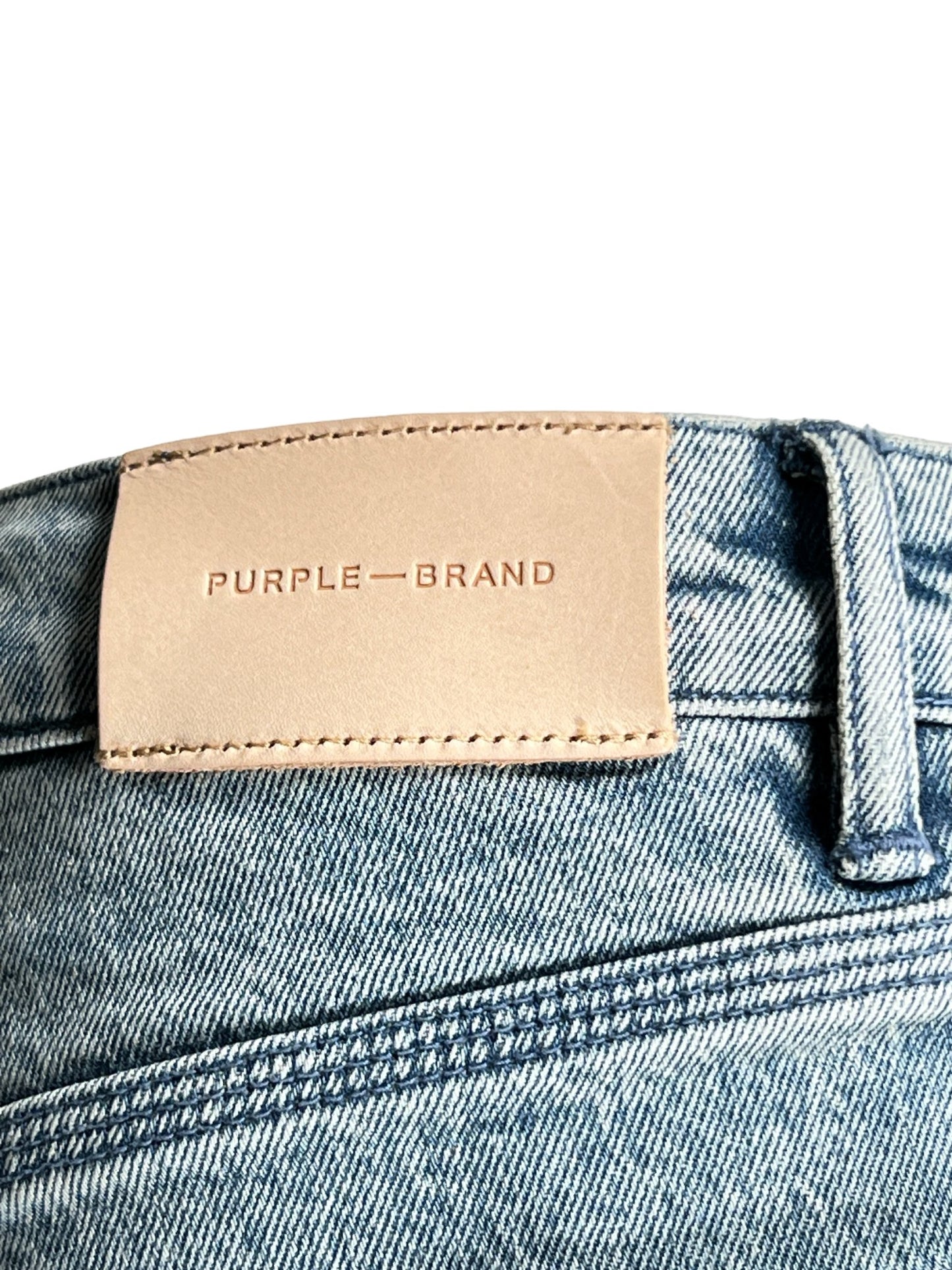 Sentence with replaced product:
Tan leather patch with "PURPLE BRAND" embossed, stitched onto PURPLE BRAND P004-VNSL VINTAGE FLARE LIGHT INDIGO jeans.