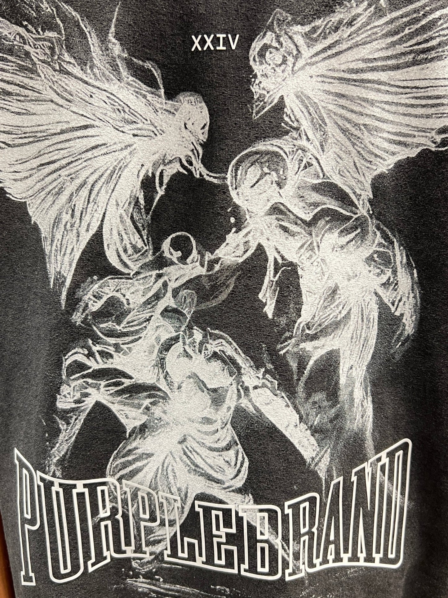The back of a PURPLE BRAND P101-JFBB TEXTURED INSIDE OUT TEE BLACK with a graphic image of an angel and a demon.