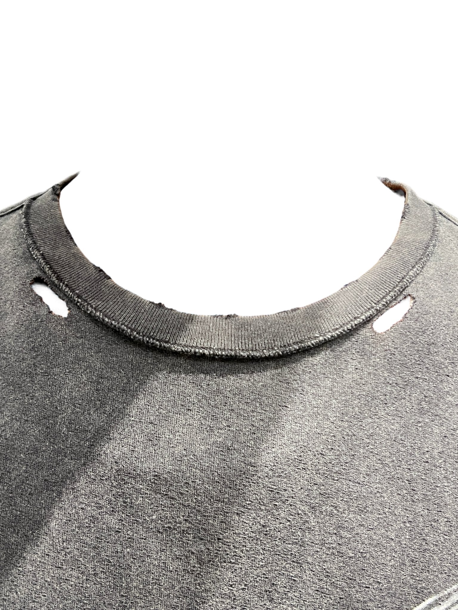 Close-up of a distressed black tee with frayed edges and holes around the neckline, showcasing Purple Brand's P101-JFBB relaxed fit crafted from premium jersey knit.