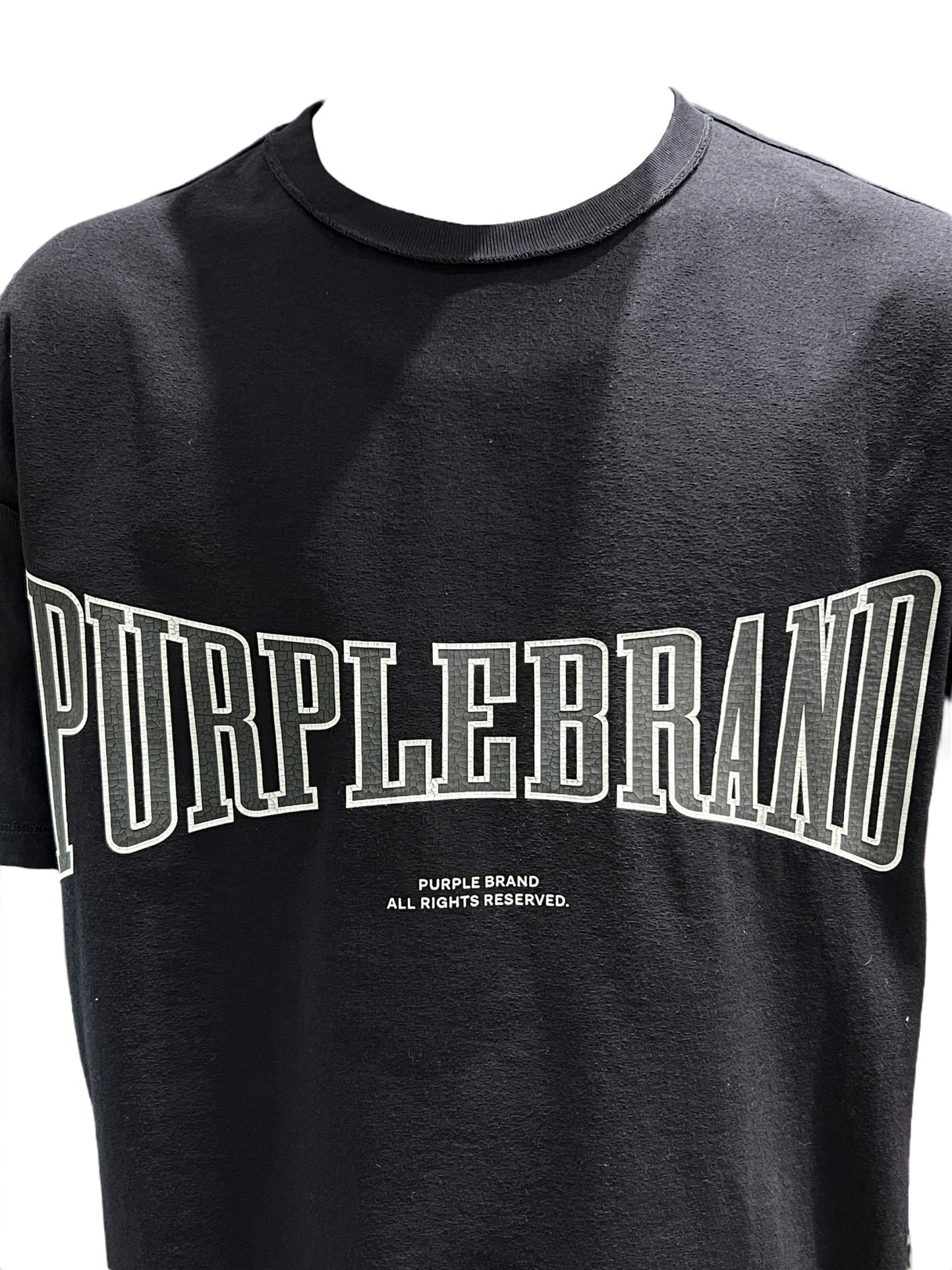 A black cotton PURPLE BRAND P101-JHBB TEXTURED INSIDE OUT TEE with the word "PURPLE BRAND" in a graphic on it.