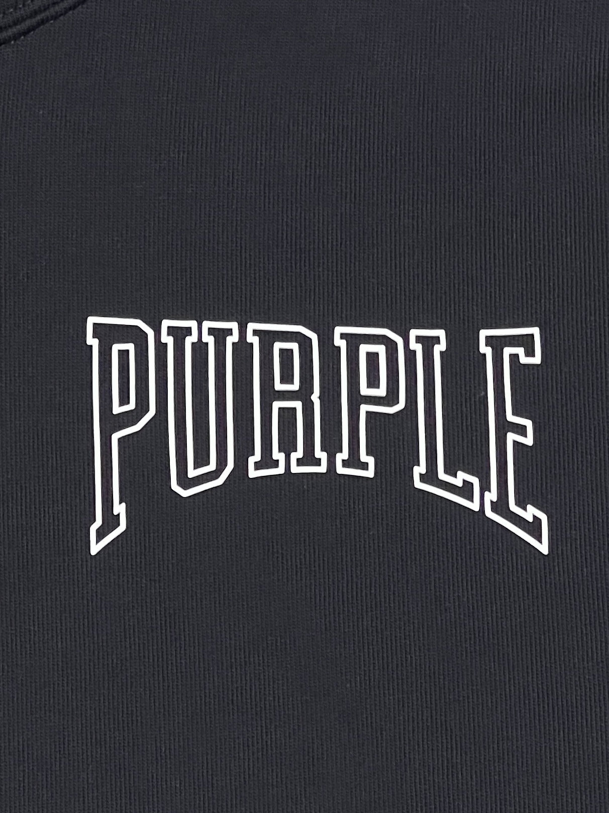 Close-up of the word "PURPLE" printed in white outline font on a BLACK PURPLE BRAND P447-FFBB FRENCH TERRY PO HOODY background.