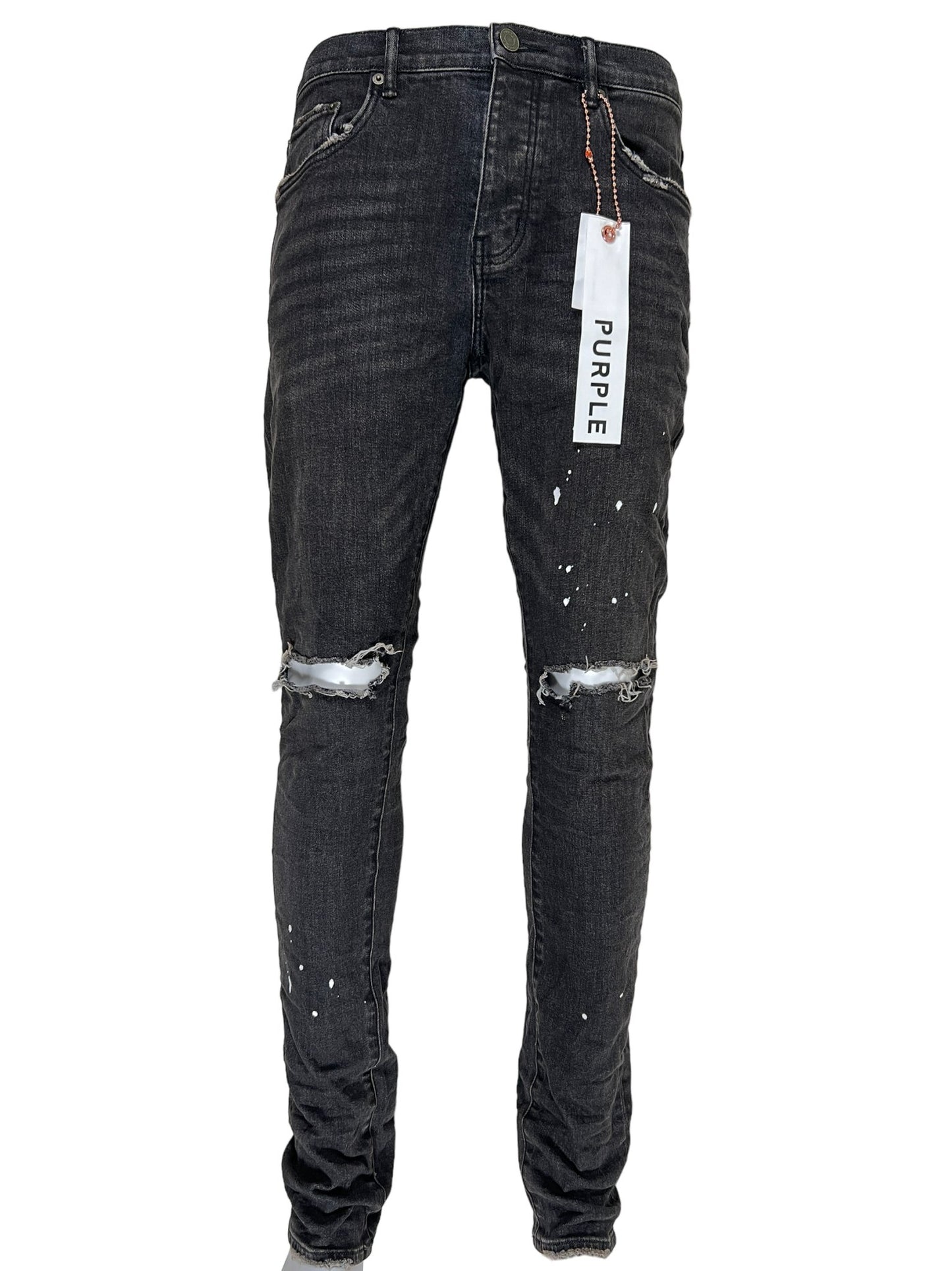 A pair of Purple Brand low rise skinny black jeans with a tag on them.