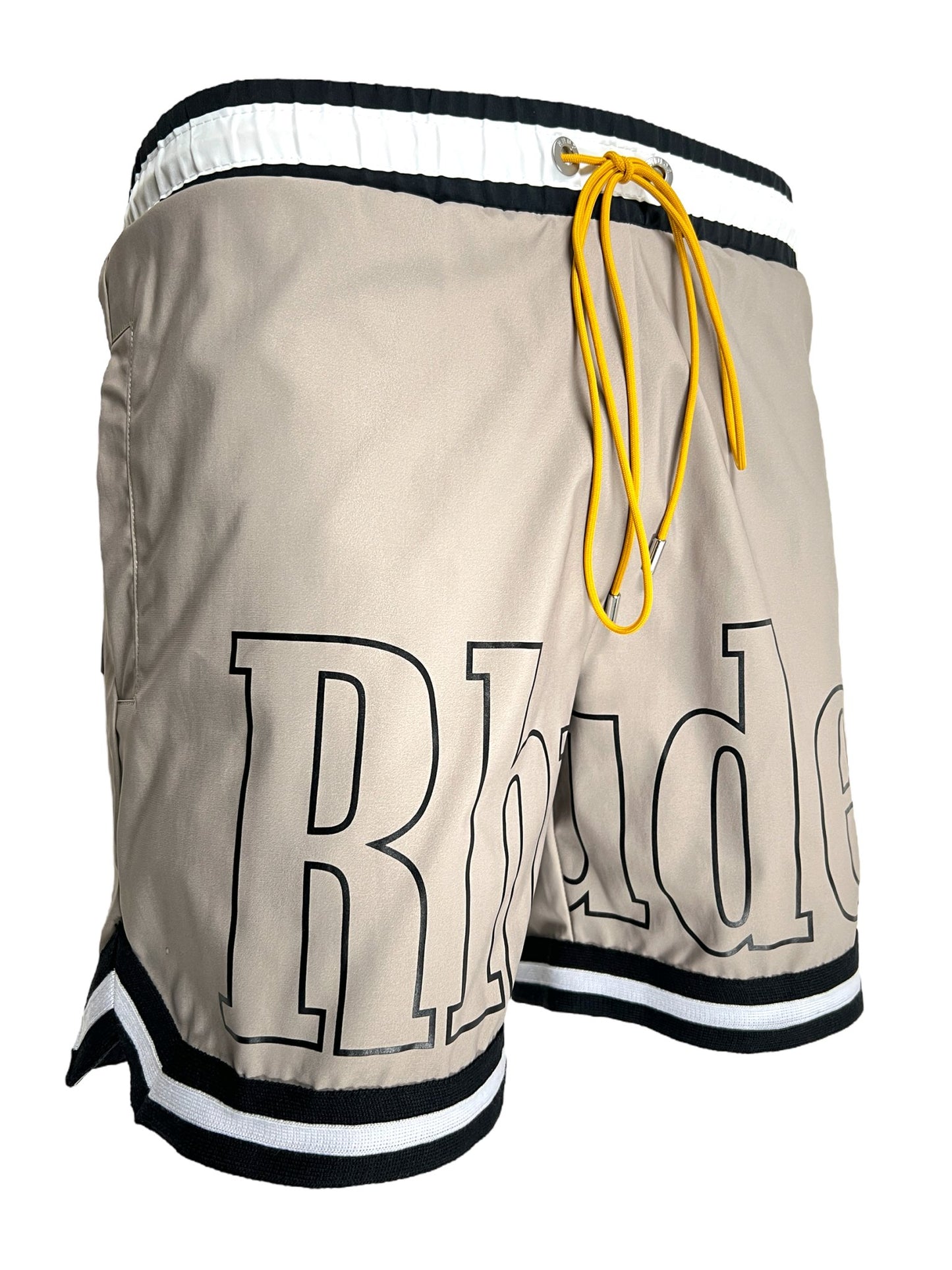 Pair of RHUDE BASKETBALL SWIM SHORT KHAKI with a contrasting trim and the word "RHUDE" printed on the side, featuring a yellow drawstring.