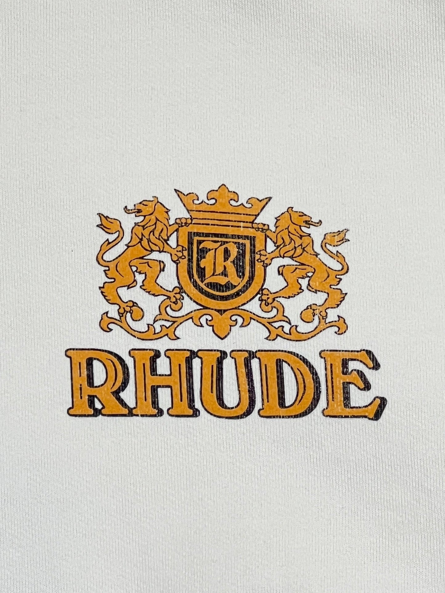 A white hoodie with the RHUDE CRESTA CIGAR HOODIE WHT logo on it, perfect for streetwear enthusiasts.