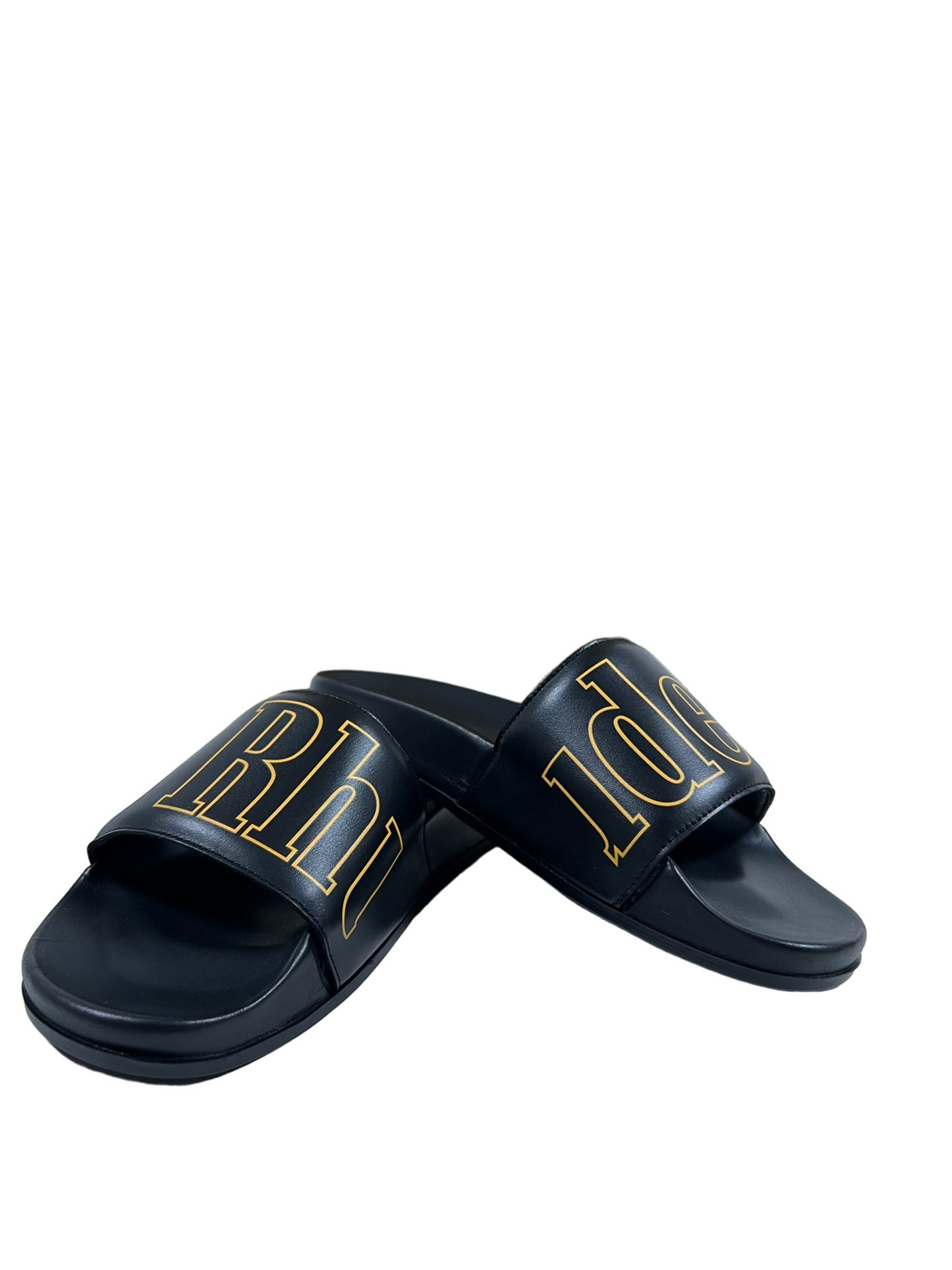 A pair of RHUDE Leather Slides in black with yellow lettering, made in Italy.