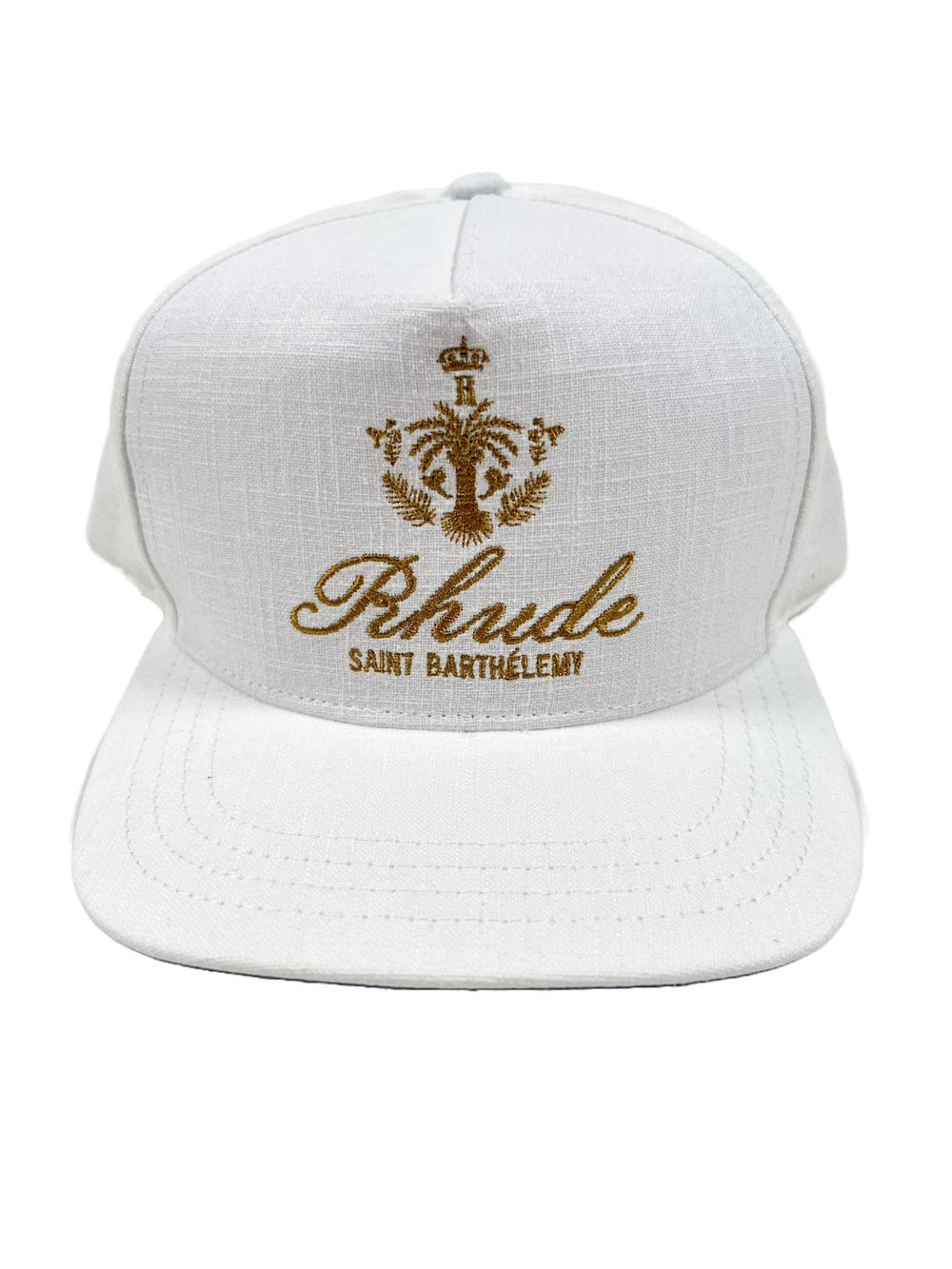 A white RHUDE ROSEWOOD HAT IVORY with a gold logo on it, made from a polyester-cotton blend.