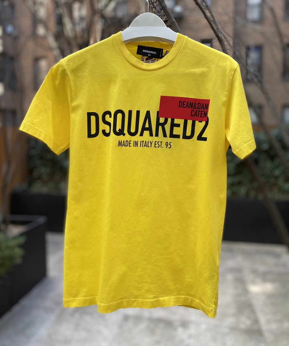 A yellow DSQUARED2 S71GD1021 t-shirt with the words DSQUARED2 on it, made in Italy.