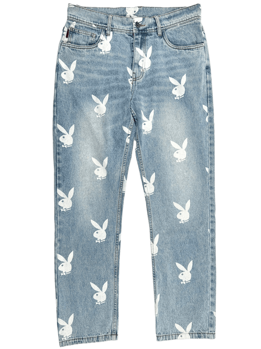 A pair of baggy fit jeans with white PLEASURES bunnies on them.