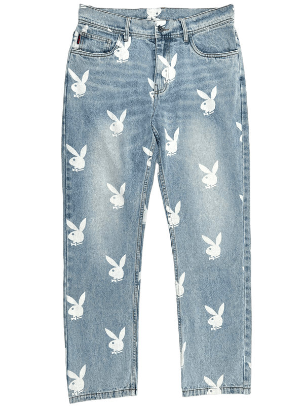 A pair of baggy fit jeans with white PLEASURES bunnies on them.