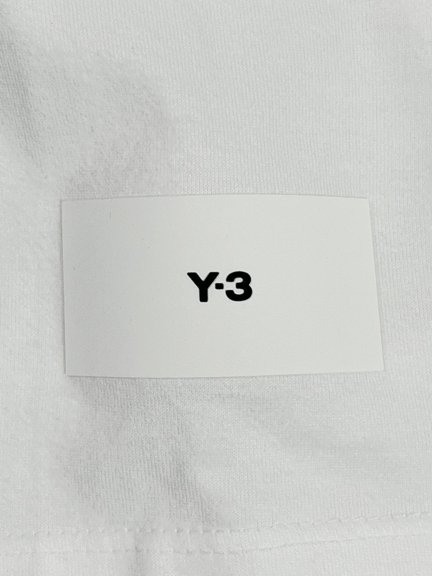 A white Y-3 IB4787 RELAXED SS TEE CORE WHITE t-shirt featuring the ADIDAS x Y-3 logo detail on it.