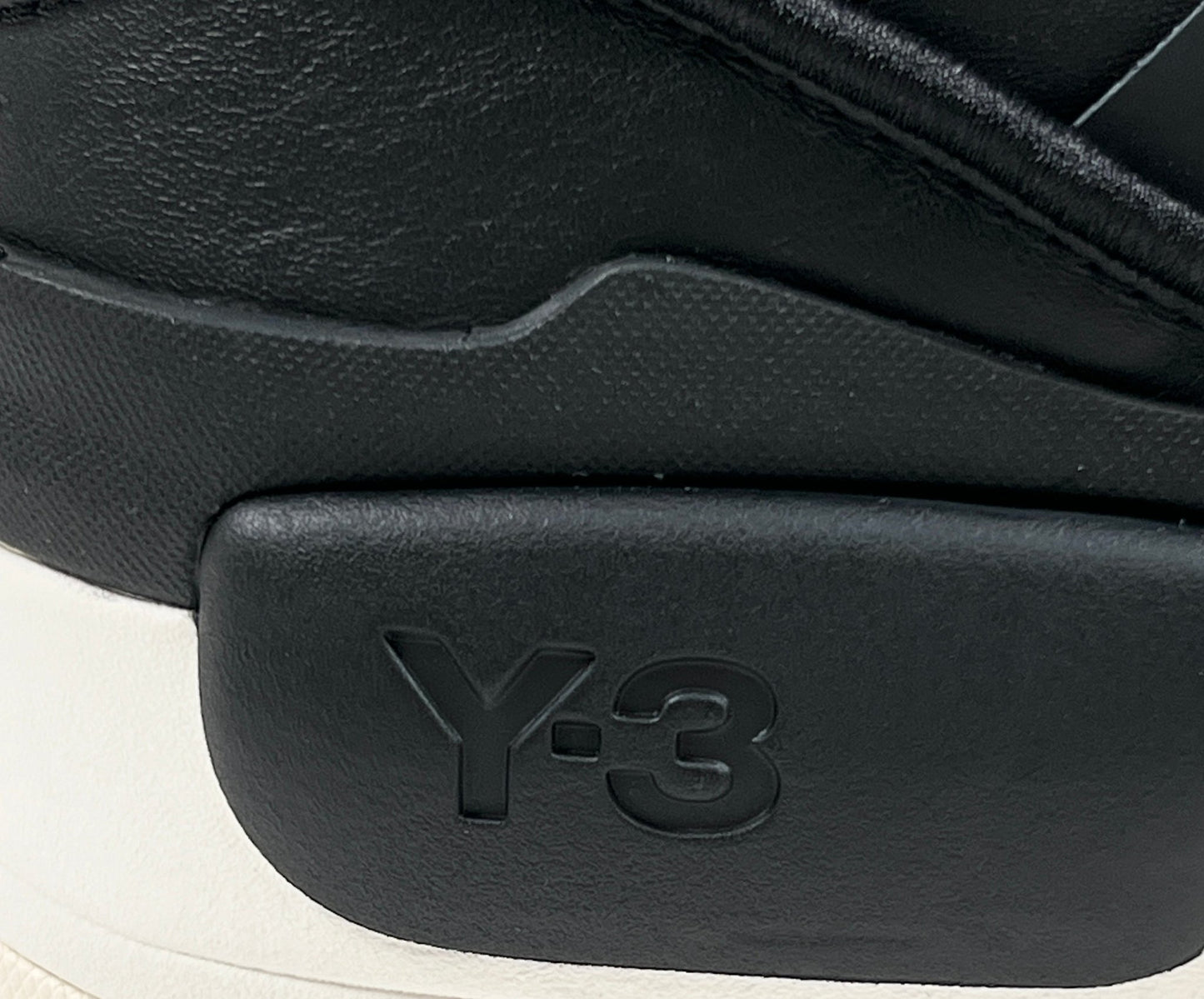 A close-up of a black and white ADIDAS x Y-3 Rivalry sneaker.