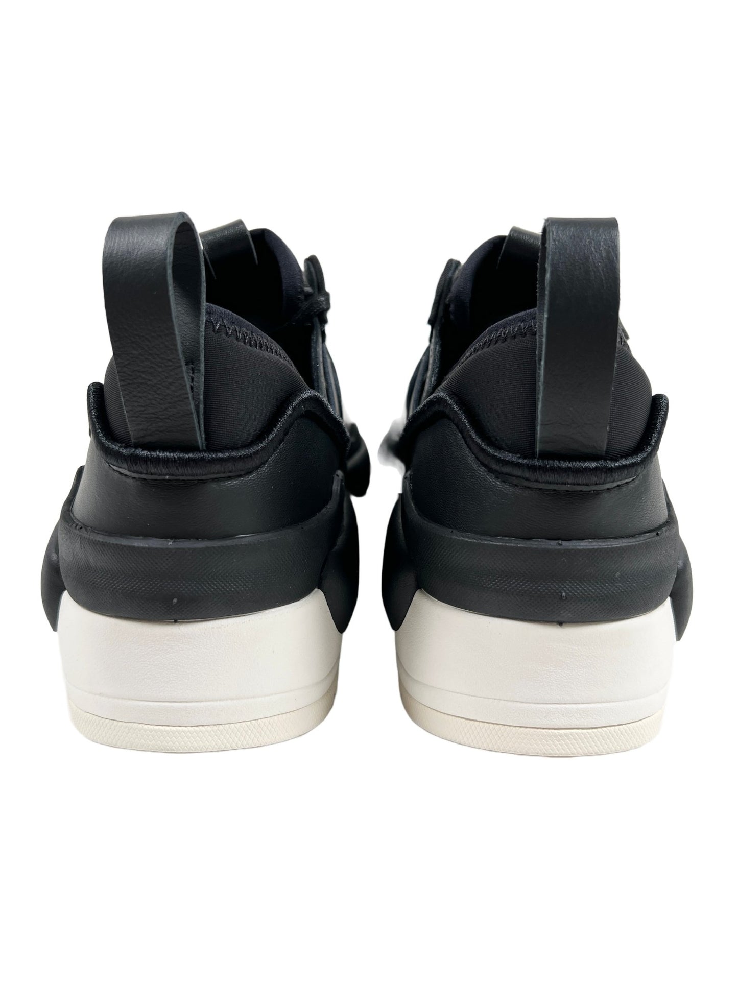 A pair of ADIDAS x Y-3 Rivalry shoes with white soles.