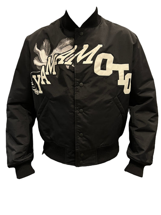 A black Y-3 IR7105 Team Jacket with a graphic logo design on it.